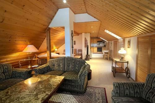 a living room with couches and a table at Haus PANORAMA - Appartement Auszeit 5 in Braunlage