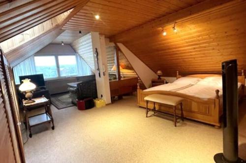 a bedroom with a large bed in a wooden room at Haus PANORAMA - Appartement Auszeit 5 in Braunlage