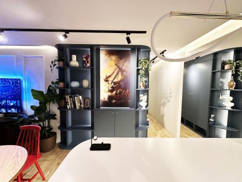 a room with a shelf with a painting on it at Ambient lounge with sundeck and free parking in Bratislava