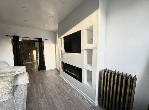 a living room with a television and a radiator at 3 bedroom Condo in Central Park/ Times Square/ Hudson Yards in New York
