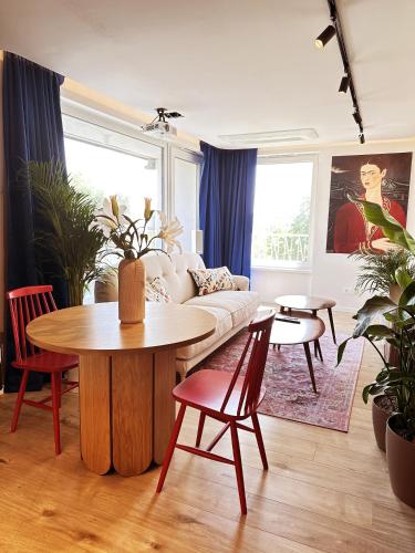 a living room with a couch and a table at Ambient lounge with sundeck and free parking in Bratislava