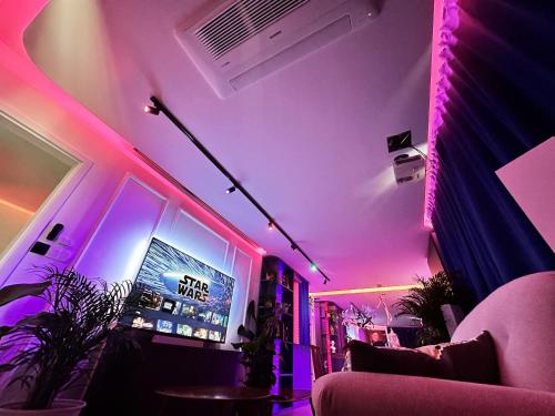 a living room with purple lights and a tv at Ambient lounge with sundeck and free parking in Bratislava