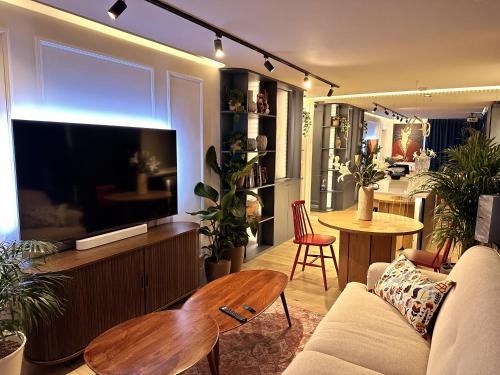 a living room with a couch and a flat screen tv at Ambient lounge with sundeck and free parking in Bratislava