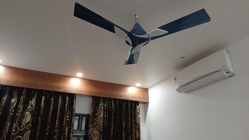 a ceiling fan hanging from the ceiling of a room at Hotel Swastik Bhumi in Gaya