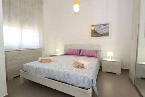 a bedroom with a bed with two bags on it at Stella apartments in Lido di Pomposa