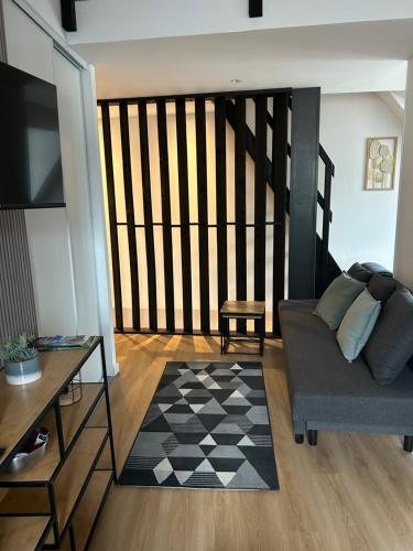 a living room with a couch and a table at Le repos de la Meuse in Givet