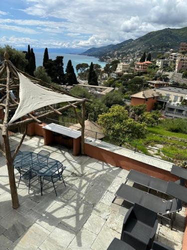 a table and chairs on a patio with a view of the water at B&B Casetta del Marinaio in Camogli
