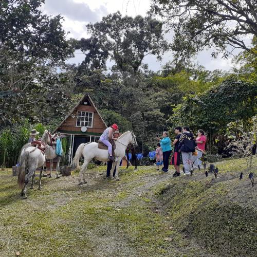 a group of people riding horses in front of a building at Glamping eco descanso la vega Nocaima in Nocaima