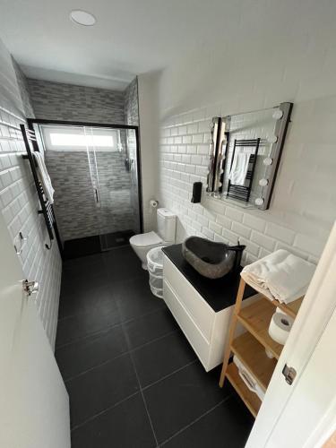 a bathroom with a sink and a toilet and a mirror at EL RINCÓN DEL NÓMADA in San Emiliano