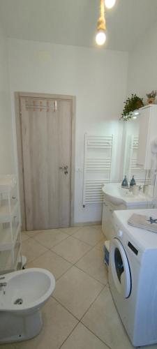 a bathroom with a toilet and a sink and a mirror at Stella Marina - voglia di vacanza e di relax in Genova
