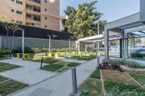 a courtyard of a building with a garden at Innvista Uwin Brooklin in Sao Paulo
