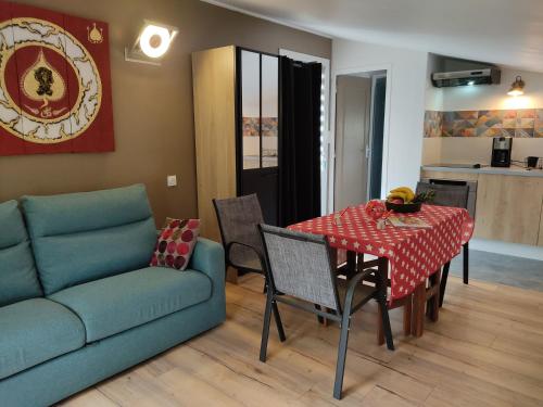 un salon avec une table et un canapé dans l'établissement Studio dans la forêt provençale, à Jouques