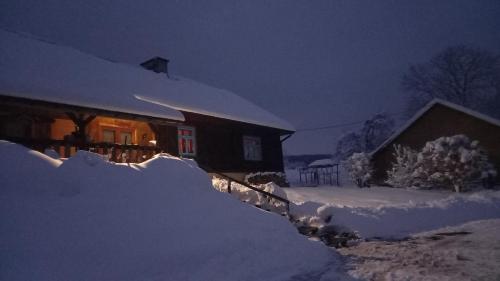 a house covered in snow at night at Dom Coacha i Mentora in Wysowa-Zdrój