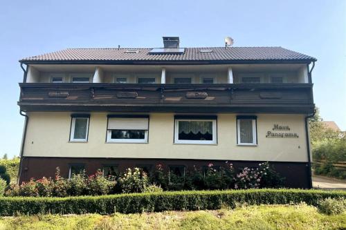 a building with windows and flowers in front of it at Haus PANORAMA - Appartement Auszeit 3 in Braunlage