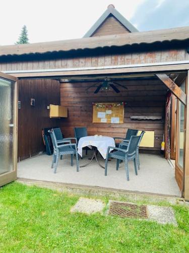 a patio with chairs and a table in a garage at Haus PANORAMA - Appartement Auszeit 3 in Braunlage