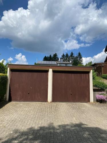 a large brown garage door on a house at Haus PANORAMA - Appartement Auszeit 3 in Braunlage