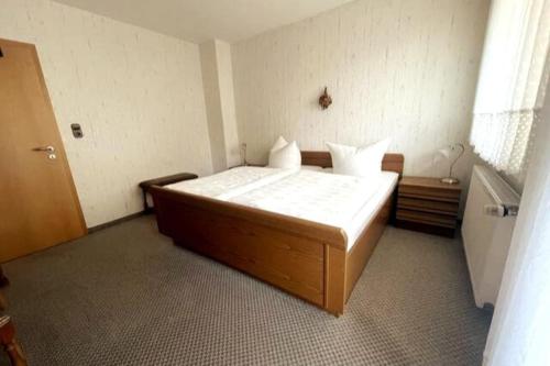 a bedroom with a large bed in a room at Haus PANORAMA - Appartement Auszeit 3 in Braunlage