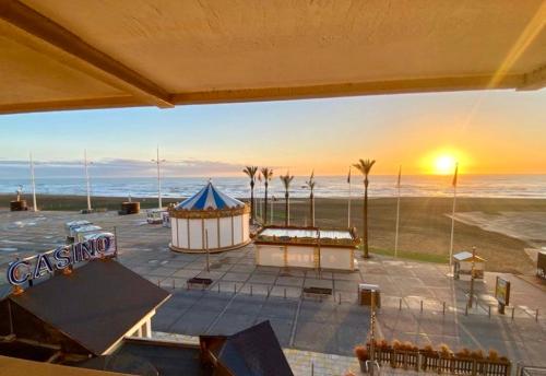 a view of a beach with a tent and the ocean at Appartement magnifique VUE MER Canet plage in Canet-en-Roussillon