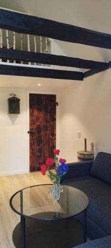 a living room with a glass table with flowers on it at Stalden in Knäred