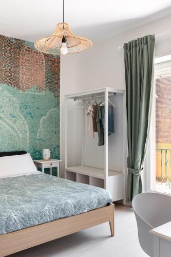 a bedroom with a bed and a green wall at B&B Sapore di Mare in Gaeta