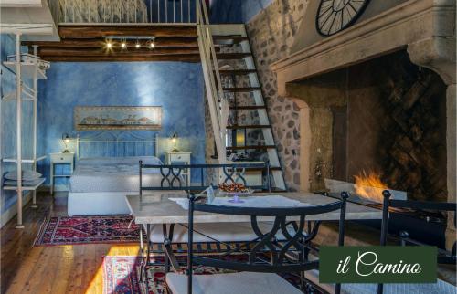 a room with a bed and a fireplace with a table at Il Borghetto Vacanze nei Mulini in Valeggio sul Mincio