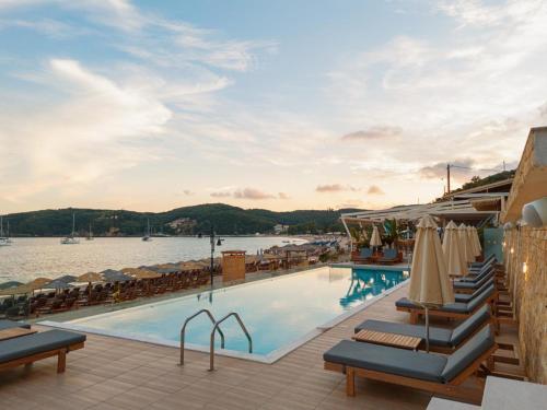 a pool at a hotel with a view of the water at Ionion Beach Resort in Parga