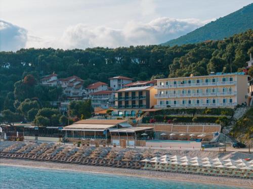 a hotel on the beach next to the water at Ionion Beach Resort in Parga