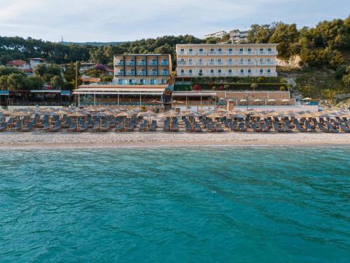a hotel on the beach with chairs and the water at Ionion Beach Resort in Parga
