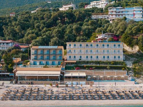 a building on the beach next to the water at Ionion Beach Resort in Parga