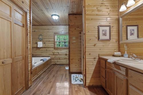 a wooden bathroom with a tub and a sink at Nature's View Retreat Serenity and Splendor in Hollister