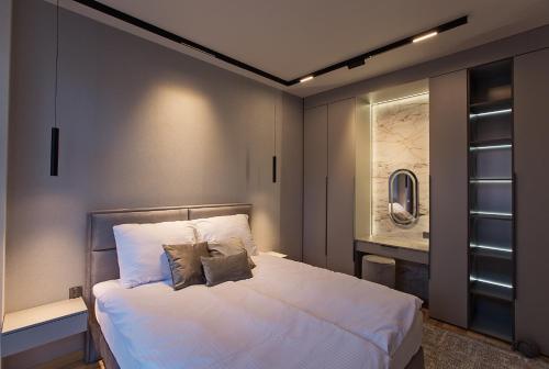 a bedroom with a large white bed with two pillows at Apartament Ułański - City Park in Poznań