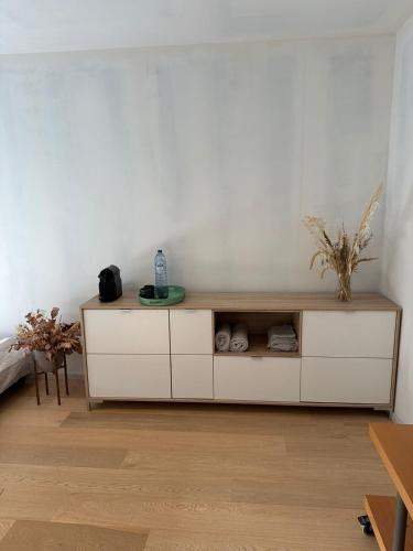 a white cabinet in a white room with at Kamer in hartje van de Vlaamse Ardennen in Oudenaarde