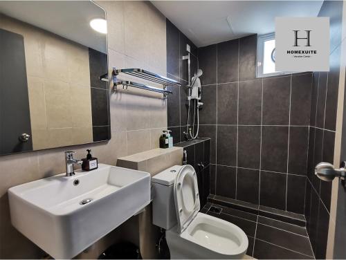 a bathroom with a sink and a toilet at Homexuite Vacation @ Sri Indah in Sandakan