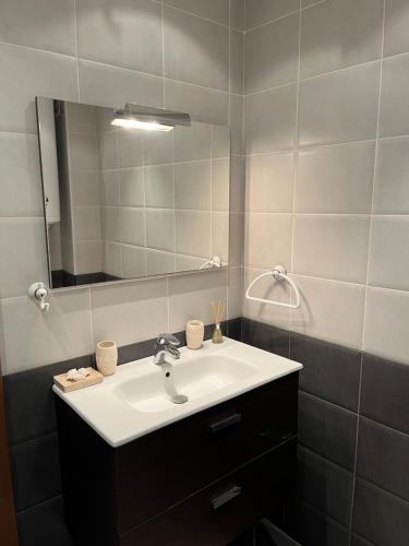 a bathroom with a sink and a mirror at Privat apartament Golf Coast in Kavarna