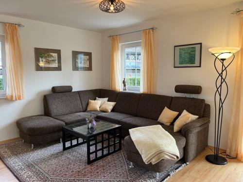 a living room with a couch and a table at Haus Ammertal in Peißenberg