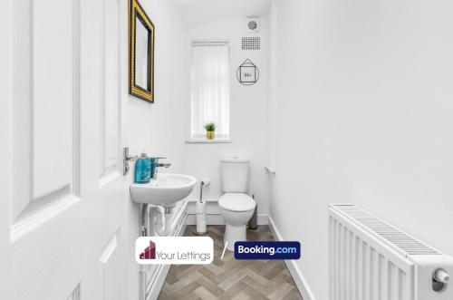 a bathroom with a toilet and a sink at Elegant 3 Bedroom Detached House By Your Lettings Short Lets & Serviced Accommodation Peterborough With Free WiFi,Parking in Brampton Grange