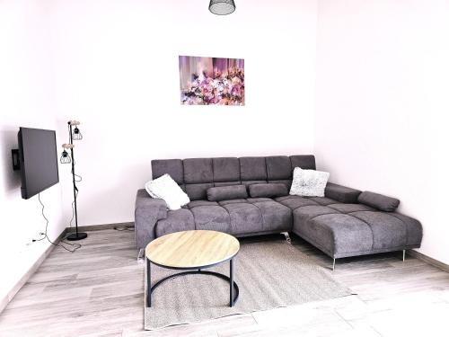 a living room with a couch and a table at MY HOME AM HEUBERG Nr 6 in Frittlingen