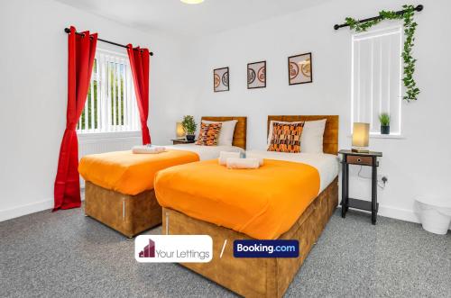 two beds in a room with red curtains at Elegant 3 Bedroom Detached House By Your Lettings Short Lets & Serviced Accommodation Peterborough With Free WiFi,Parking in Brampton Grange