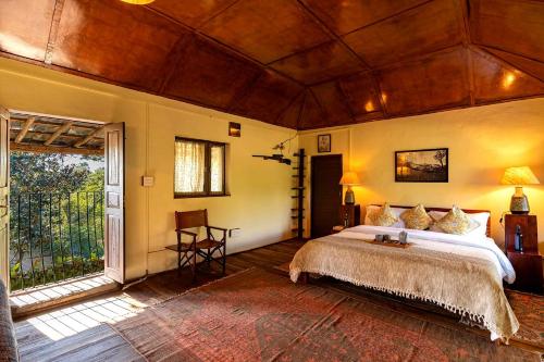 a bedroom with a large bed and a large window at Private & Scenic Serene 2BR Villa in Dharamshala in Dharamshala