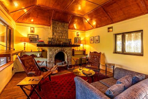 a living room with a couch and a fireplace at Private & Scenic Serene 2BR Villa in Dharamshala in Dharamshala
