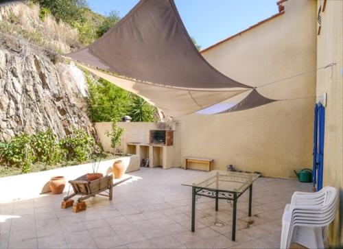 un patio avec une table et des chaises et une table sidx sidx dans l'établissement Le Nid de Gilles, à Collioure