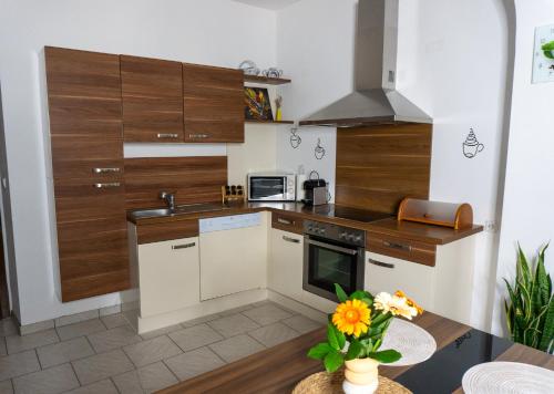 a kitchen with wooden cabinets and a counter top at (W)einHaus am See in Rust