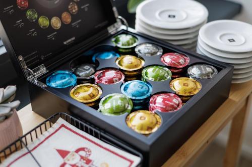 a box of chocolates on a table with plates at River Apartments in Mladá Boleslav
