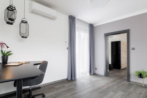 an office with a table and chairs and a hallway at River Apartments in Mladá Boleslav