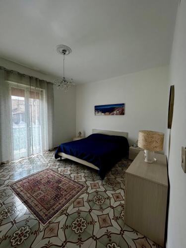 a bedroom with a bed and a rug on the floor at GRC Apartments Partanna-Mondello in Palermo