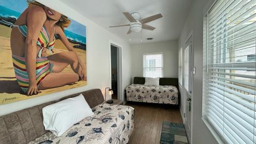 a living room with a couch and a painting of a woman at Sea Gull Motel in Wildwood