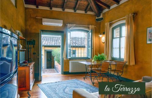 a living room with a table and chairs and windows at Il Borghetto Vacanze nei Mulini in Valeggio sul Mincio