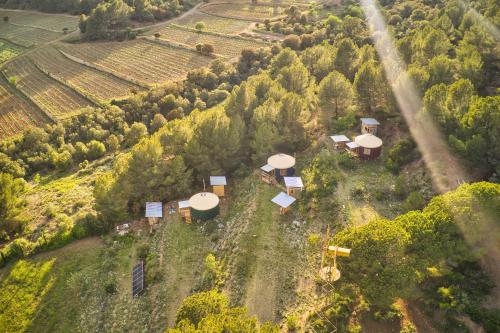 an aerial view of a farm with a group of houses at La Muntanera - Eco Yurt - Pool, Nature retreat in Figuerola
