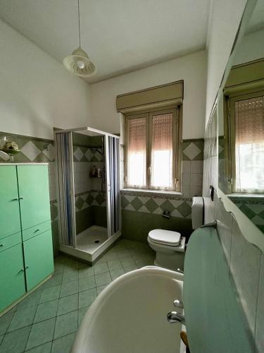 a bathroom with a tub and a toilet and a sink at GRC Apartments Partanna-Mondello in Palermo