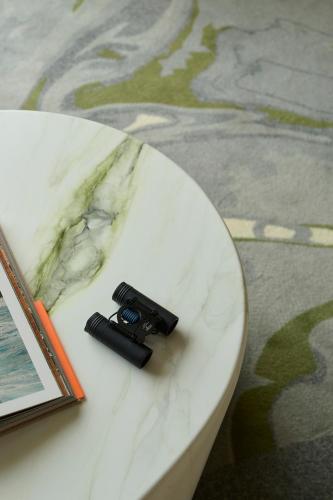 a gun sitting on a table next to a book at Octant Ponta Delgada in Ponta Delgada